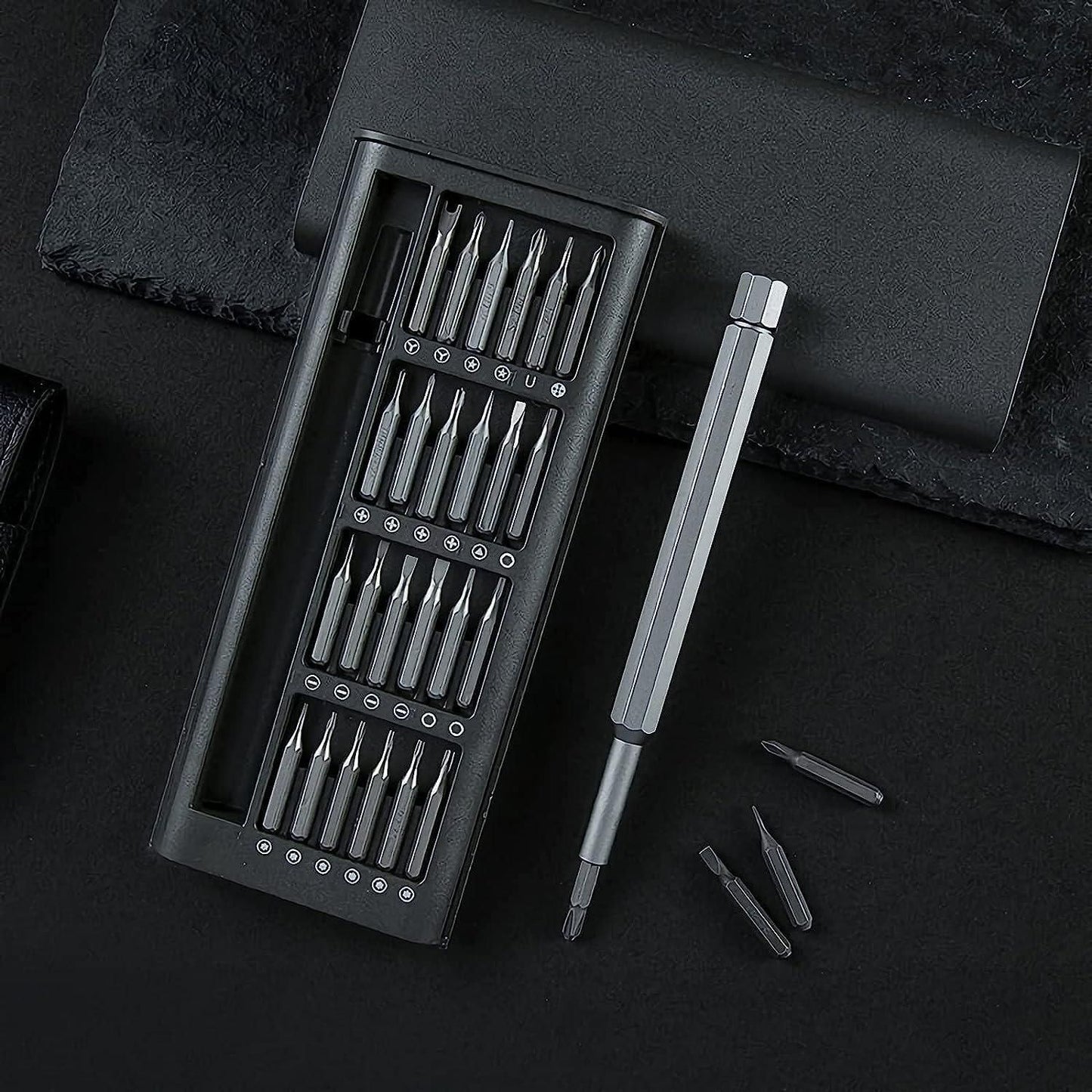 Set of screwdrivers in a black case on a dark surface
