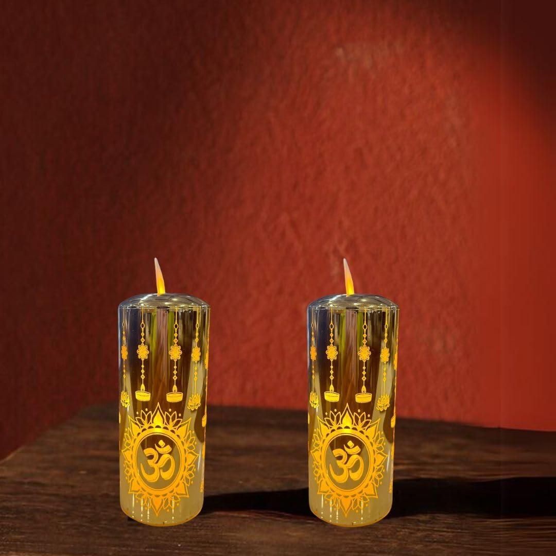 Two lit candles with decorative designs on a wooden surface against a red background