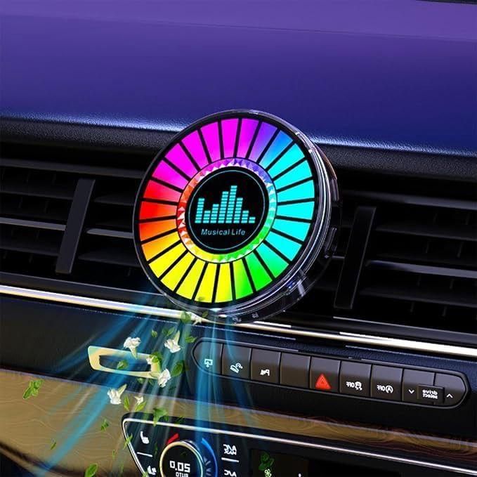 Colorful car air freshener with a rainbow design on a car dashboard.