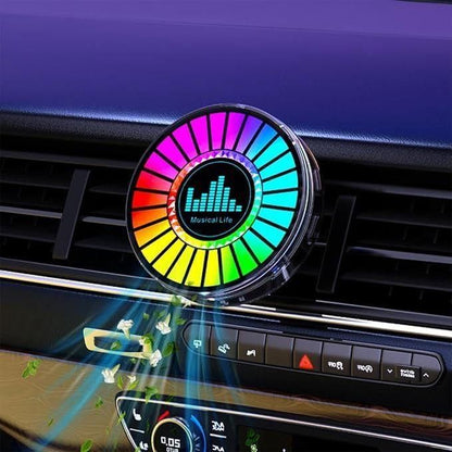 Colorful car air freshener with a rainbow design on a car dashboard.